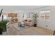 Open concept living space with wood floors, neutral walls, a dining area, a kitchen, and natural light at 3709 Neblina Dr, Henderson, NV 89052