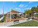 Community playground with covered play area, benches, and landscaping, offering a safe and fun space for  at 3709 Neblina Dr, Henderson, NV 89052