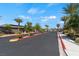 Gated Community Entrance with palm trees and landscaped median, ensuring privacy and a grand arrival at 3709 Neblina Dr, Henderson, NV 89052