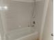 Standard bathtub with tiled walls at 3965 Rebecca Raiter Ave # 201, Las Vegas, NV 89110
