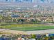 Community aerial view featuring a green recreational field, palm trees, and expansive residential area at 4114 Jessica Marie St, North Las Vegas, NV 89032