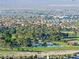 Wide community view showcasing lush green space and a serene pond surrounded by trees, ideal for recreation at 4114 Jessica Marie St, North Las Vegas, NV 89032