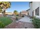 Backyard boasting a lush lawn, palm trees, and a stone patio, creating an oasis for relaxation and entertainment at 4114 Jessica Marie St, North Las Vegas, NV 89032