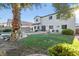 Backyard offers lush lawn, palm trees, and covered patio provides a private and tranquil outdoor experience at 4114 Jessica Marie St, North Las Vegas, NV 89032