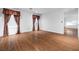Bonus room with dark wood floors and a window with dark patterned curtains at 4114 Jessica Marie St, North Las Vegas, NV 89032