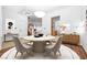 Bright dining room features a round table with a white rug under the table and stylish sideboard with decorative accents at 4114 Jessica Marie St, North Las Vegas, NV 89032