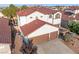 This home features a 2 car garage, tidy landscaping, and terra cotta colored roof at 4114 Jessica Marie St, North Las Vegas, NV 89032