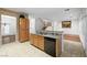 Spacious kitchen featuring a breakfast bar, granite countertops, and stainless steel appliances, with hardwood floors nearby at 4114 Jessica Marie St, North Las Vegas, NV 89032