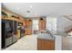 Traditional kitchen with wood cabinetry, stainless steel appliances, and a breakfast bar at 4114 Jessica Marie St, North Las Vegas, NV 89032