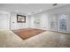 Open living room with a blend of tiled and wood flooring and a pair of French doors leading to the outside at 4114 Jessica Marie St, North Las Vegas, NV 89032