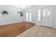 Spacious living room featuring hardwood floor, chandelier, and a front door with leaded glass at 4114 Jessica Marie St, North Las Vegas, NV 89032