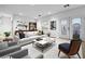 Well-lit living room featuring a plush white sofa, stylish decor, and sliding doors to the outdoor area at 4114 Jessica Marie St, North Las Vegas, NV 89032