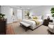 Staged main bedroom with neutral decor, wood floors, plants, and natural light creating a relaxing atmosphere at 4114 Jessica Marie St, North Las Vegas, NV 89032