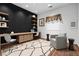 Stylish home office with wood floors, a modern desk with built-in drawers, shelving, and comfortable seating at 4114 Jessica Marie St, North Las Vegas, NV 89032