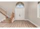 Bright entryway boasts soaring ceilings, wood staircase, and an elegant chandelier at 432 Emerald Heights St, Las Vegas, NV 89144