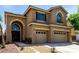 Two-story home features a three-car garage, covered porch and desert landscaping at 432 Emerald Heights St, Las Vegas, NV 89144