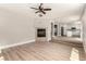Open-concept living room with wood-look flooring and seamless flow to kitchen at 432 Emerald Heights St, Las Vegas, NV 89144