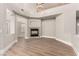 Spacious living room with a fireplace and wood-look flooring and a vaulted ceiling at 432 Emerald Heights St, Las Vegas, NV 89144