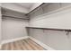 A walk-in closet with ample shelving and wood-look flooring at 432 Emerald Heights St, Las Vegas, NV 89144