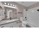 Modern bathroom featuring white tiled shower, white toilet, vanity with gray countertop, and a large mirror at 4324 W Lake Mead Blvd # 202, Las Vegas, NV 89108