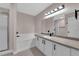 Bright bathroom featuring white cabinets, shower, and modern fixtures, with a large vanity and mirror at 4324 W Lake Mead Blvd # 202, Las Vegas, NV 89108