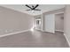 Neutral bedroom with a ceiling fan, window with blinds, gray flooring and a closet with sliding doors at 4324 W Lake Mead Blvd # 202, Las Vegas, NV 89108