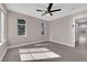 Bright bedroom with gray flooring, ceiling fan, and bright windows creating a comfortable space at 4324 W Lake Mead Blvd # 202, Las Vegas, NV 89108