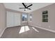 Well-lit bedroom featuring gray flooring, ceiling fan, and closet with sliding doors at 4324 W Lake Mead Blvd # 202, Las Vegas, NV 89108