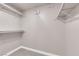 Bright walk-in closet with white shelving and gray flooring for organized storage at 4324 W Lake Mead Blvd # 202, Las Vegas, NV 89108
