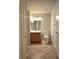 A well-lit bathroom features a tiled floor, vanity, and toilet, providing a functional and inviting space at 4675 Basilicata Ln # 103, North Las Vegas, NV 89084