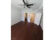 Spacious bedroom featuring hardwood floors, ceiling fan and ensuite bathroom and walk in closet at 4675 Basilicata Ln # 103, North Las Vegas, NV 89084