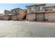 Exterior view of community townhouses with garage parking at 4675 Basilicata Ln # 103, North Las Vegas, NV 89084