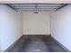 Clean, empty garage featuring concrete floors and white walls at 4675 Basilicata Ln # 103, North Las Vegas, NV 89084