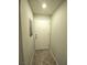 A hallway with a textured wall leads to a white door and has neutral flooring at 4675 Basilicata Ln # 103, North Las Vegas, NV 89084