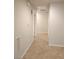 Hallway featuring neutral walls and flooring, leading to other rooms in the home at 4675 Basilicata Ln # 103, North Las Vegas, NV 89084