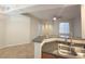 Kitchen with a breakfast bar, stainless steel sink, and tile flooring at 4675 Basilicata Ln # 103, North Las Vegas, NV 89084