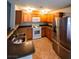 Spacious kitchen with oak cabinets, tile floors, and stainless steel refrigerator at 4675 Basilicata Ln # 103, North Las Vegas, NV 89084