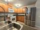 Well-equipped kitchen featuring stainless steel refrigerator and matching appliances at 4675 Basilicata Ln # 103, North Las Vegas, NV 89084