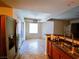 Open concept kitchen with a stainless steel fridge and a double sink at 4675 Basilicata Ln # 103, North Las Vegas, NV 89084