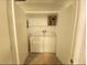 The laundry closet features a washer and dryer hookup on a tile floor with storage shelving at 4675 Basilicata Ln # 103, North Las Vegas, NV 89084