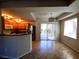 Open-concept living space featuring updated tile flooring, stylish light fixture, and access to an outdoor balcony at 4675 Basilicata Ln # 103, North Las Vegas, NV 89084