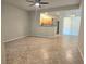 Bright living room featuring tile floors, ceiling fan, and view of the kitchen with stainless steel appliances at 4675 Basilicata Ln # 103, North Las Vegas, NV 89084