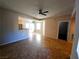 Open-concept living room with patio access, modern light fixture, and neutral tile at 4675 Basilicata Ln # 103, North Las Vegas, NV 89084