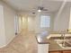 Open concept living area showcasing tile floors, a kitchen island, and ample natural light at 4675 Basilicata Ln # 103, North Las Vegas, NV 89084