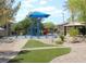 Park area with playground and a picnic pavilion on a sunny day at 4675 Basilicata Ln # 103, North Las Vegas, NV 89084