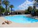 Community pool with poolside seating and clear blue water at 4675 Basilicata Ln # 103, North Las Vegas, NV 89084