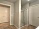 A bright bathroom includes a tiled shower with sliding glass doors and convenient access to the closet at 4675 Basilicata Ln # 103, North Las Vegas, NV 89084
