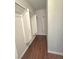 Inside the walk-in closet, find ample hanging space and wood flooring, perfect for organized storage at 4675 Basilicata Ln # 103, North Las Vegas, NV 89084
