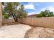 Fenced backyard featuring a stamped concrete patio and mature tree providing cool shade at 4705 Delicate Arch Ct, North Las Vegas, NV 89031