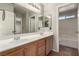 Dual sink bathroom vanity features tile floor and bright lighting at 4705 Delicate Arch Ct, North Las Vegas, NV 89031